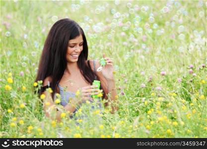 happy woman smile in green grass soap bubbles around