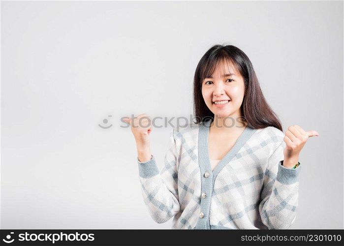 Happy woman smile showing finger thumbs up, Portrait Asian beautiful young female successful like finger gesture, OK sign to agree studio shot isolated on white background with copy space