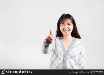Happy woman smile showing finger thumbs up, Portrait Asian beautiful young female successful like finger gesture, OK sign to agree studio shot isolated on white background with copy space