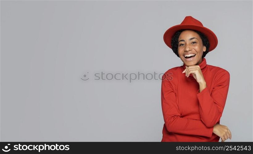 happy woman smiling while posing with hat copy space