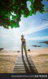 happy woman stand on wood bridge with view of the sea, soft focus with noise