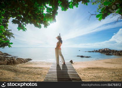 happy woman stand on wood bridge with view of the sea, soft focus with noise