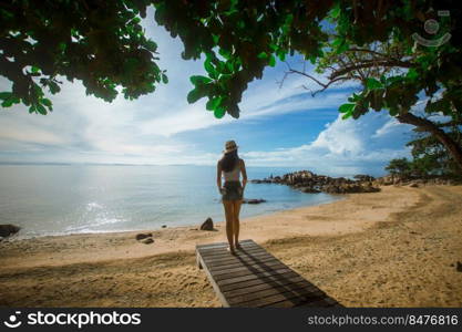 happy woman stand on wood bridge with view of the sea, soft focus with noise