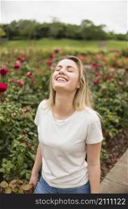happy woman standing flower garden