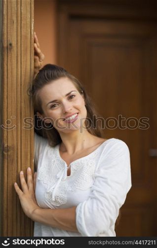 Happy woman standing on doorstep