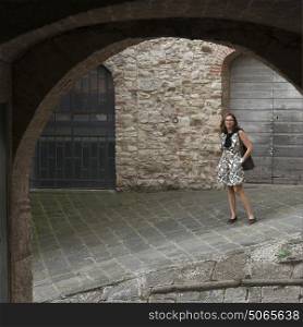 Happy woman standing on street, Radda in Chianti, Tuscany, Italy