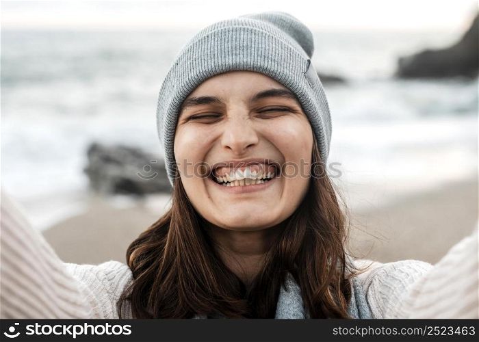 happy woman taking selfie beach