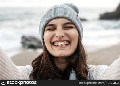 happy woman taking selfie beach