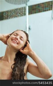 Happy woman taking shower