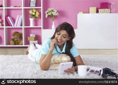 Happy woman using digital tablet at home