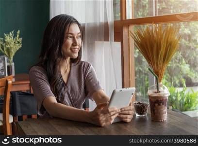 happy woman using tablet in the cafe