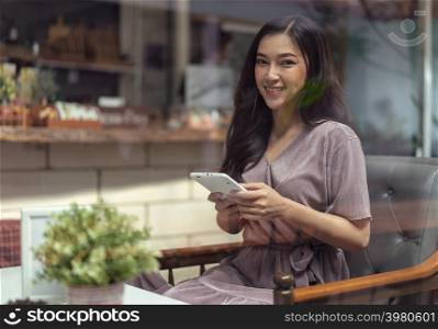 happy woman using tablet in the cafe