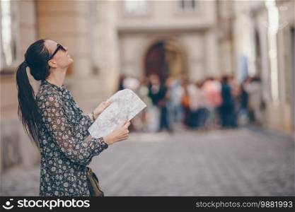 Happy woman walking in european street. Young attractive tourist outdoors in Vienna city on the street where lived Mozart. Woman walking in city. Young attractive tourist outdoors in italian city