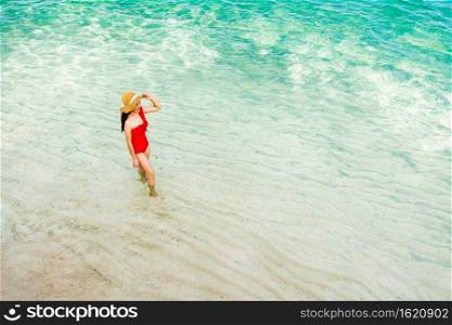 happy woman walking on the sea beach at Koh MunNork Island, Rayong, Thailand