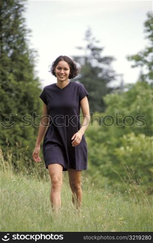 Happy Woman Walking Through Field