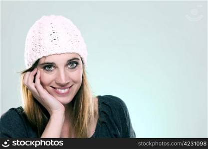 happy woman wearing a winter cap. happy woman wearing a winter cap on light blue background
