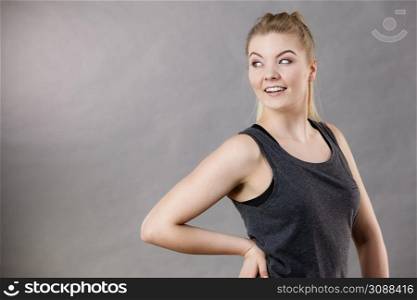 Happy woman wearing black tank top smiling having good mood. Sporty outfit. Happy woman wearing black tank top