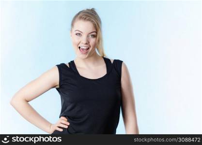 Happy woman wearing black tank top smiling having good mood. Sporty outfit. Happy woman wearing black tank top