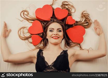 Happy woman wearing lingerie in bed at home. Attractive seductive young girl with heart shape boxes around head. Female underwear fashion. Valentines day love.. Woman in lingerie in bed. Valentines day love.