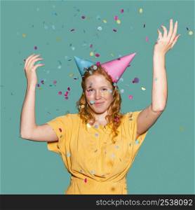 happy woman wearing two birthday cones