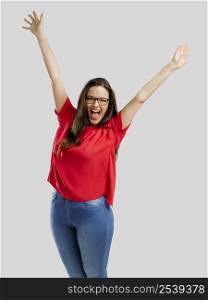 Happy woman with arms up, isolated over white background