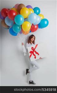 Happy woman with balloons. Happy woman with many colorful balloons and gift box