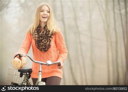 Happy woman with bike bicycle in autumn park.. Happy active woman with bike bicycle in foggy fall autumn park. Smiling young girl in sweater relaxing. Healthy lifestyle and recreation leisure activity.