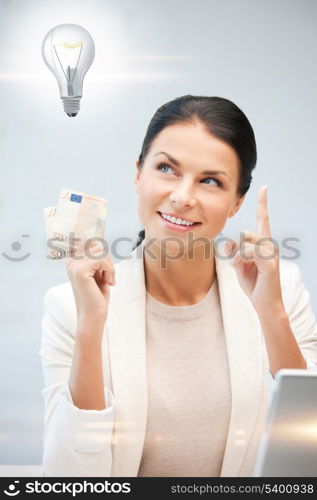 happy woman with cash euro money and light bulb