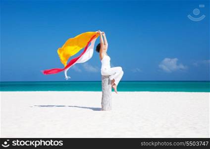 happy woman with colorful sarongs on the beach