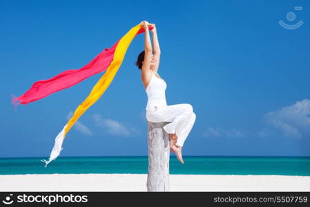 happy woman with colorful sarongs on the beach