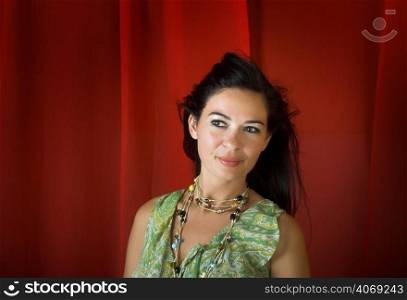 Happy woman with dark hair on red