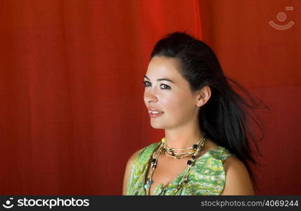 Happy woman with dark hair on red
