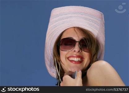Happy woman with hat by sunny day