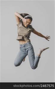 happy woman with headphones jumping air 2