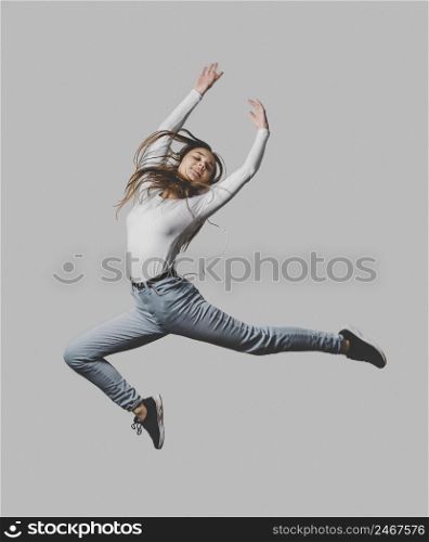 happy woman with headphones jumping air