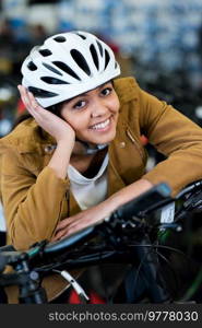 happy woman with helmet for cycling in store