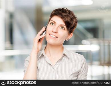 happy woman with mobile phone and space left in the office
