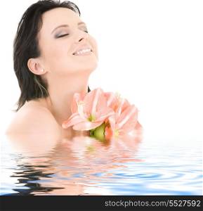 happy woman with pink madonna lily flowers in water