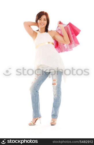 happy woman with pink shopping bags over white