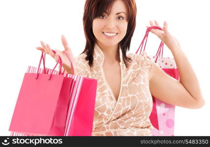 happy woman with pink shopping bags over white