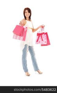 happy woman with pink shopping bags over white