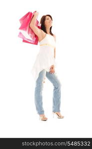 happy woman with pink shopping bags over white