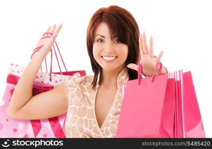 happy woman with pink shopping bags over white