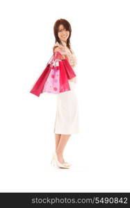 happy woman with pink shopping bags over white