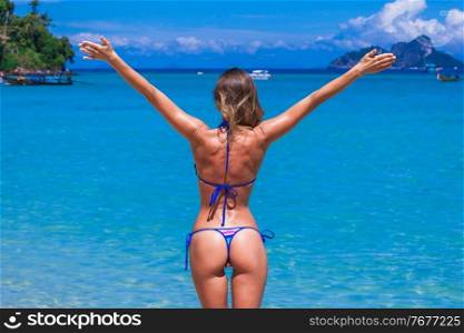 Happy woman with raised hands on beach in Thailand. Happy woman on beach