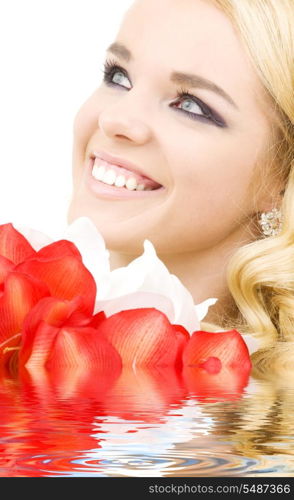 happy woman with red and white lily flowers in water