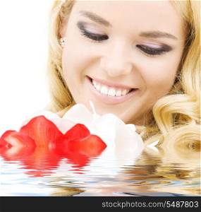 happy woman with red and white lily flowers in water