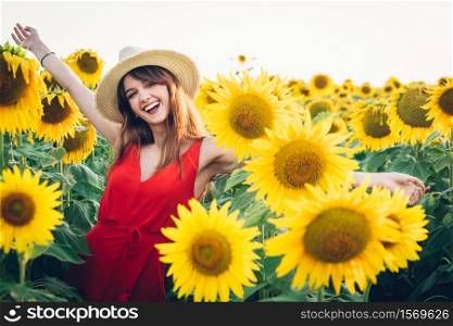 happy woman with red dress and hat in field of sunflowers.. happy woman with red dress and hat in field of sunflowers