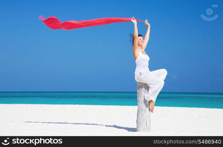 happy woman with red sarong on the beach