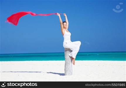 happy woman with red sarong on the beach